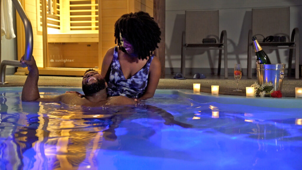 Romantic couple in a private pool at Belamere Suites.