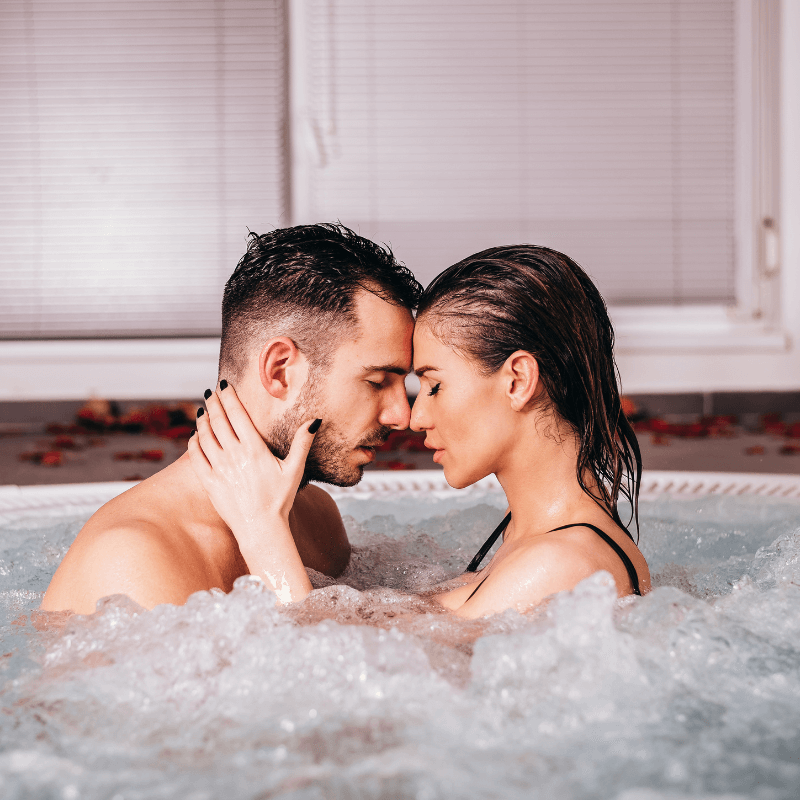 Romantic couple in an indoor pool suite at Belamere Suites.